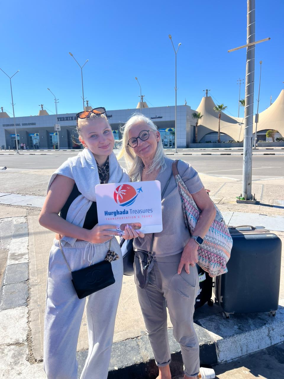 Happy guests with Hurghada Treasures sign at Hurghada Airport